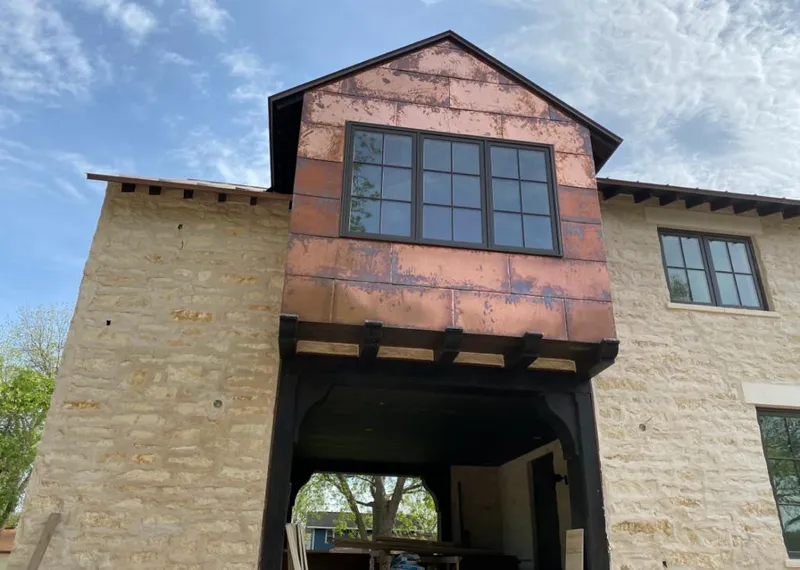 Copper metal panel facade on a stone building for Skylight Installation in Wekiwa Springs